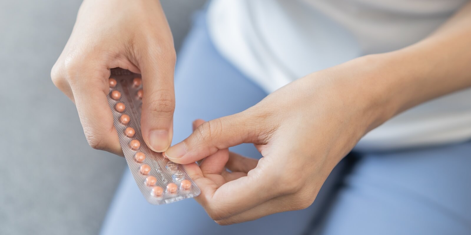 contraception and pregnancy concept asian young woman hand open birth control pills in Raleigh, NC