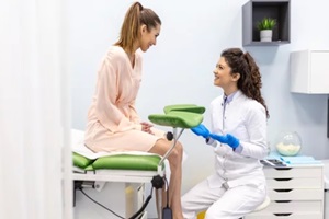 gynecologist talking with young female patient during medical consultation in modern clinic