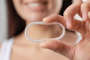woman holding diaphragm vaginal contraceptive ring on blurred background in Raleigh, NC