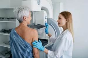 senior woman having mammography scan at hospital with medical technician