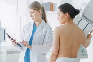 women and doctor during mammogram process