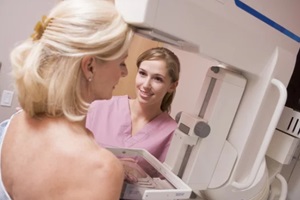 nurse assisting patient undergoing mammogram