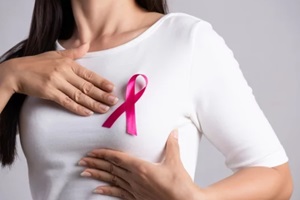 pink badge ribbon on woman chest to support breast cancer cause