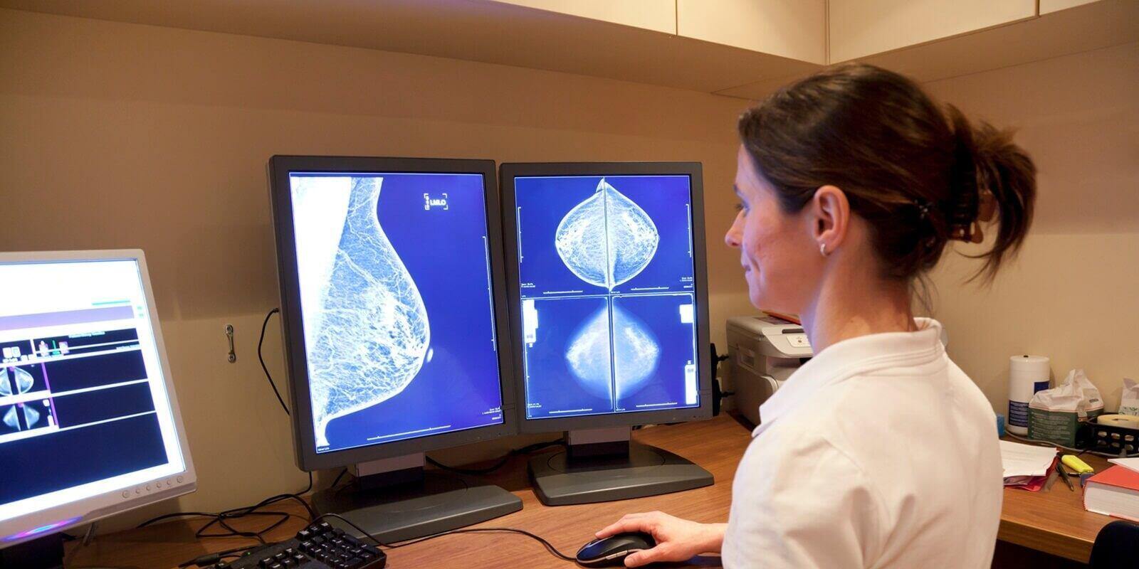 radiology technician looking at mammography in Raleigh obgyn