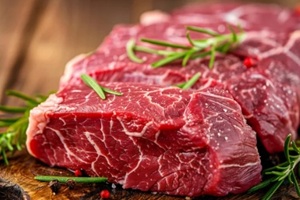 raw red meat on a wooden board