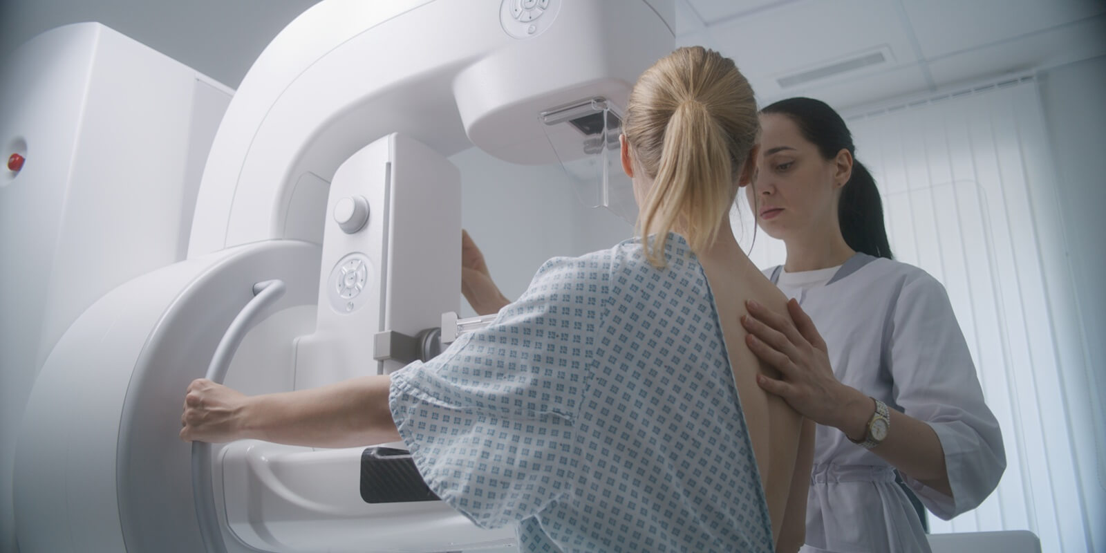 caucasian woman stands during mammography screening examination in Raleigh, NC clinic