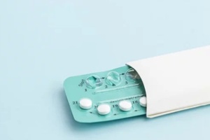 contraception pills on blue background