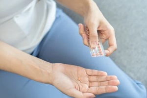 contraception and pregnancy concept asian young woman, girl hand opening birth control pills