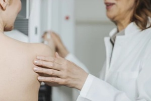 OBGYN conducting mammography screening on NC patient