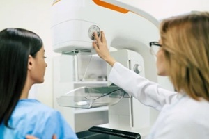 young woman is having mammogram examination at Raleigh, NC OBGYN with a professional female doctor