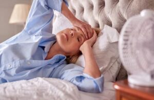 menopausal mature woman suffering with insomnia in bed