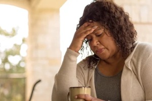 aged lady having coffee during menopause period