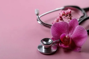 stethoscope and pink orchid represent the importance of women's health, emphasizing awareness and care