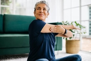 aged women doing yoga at home