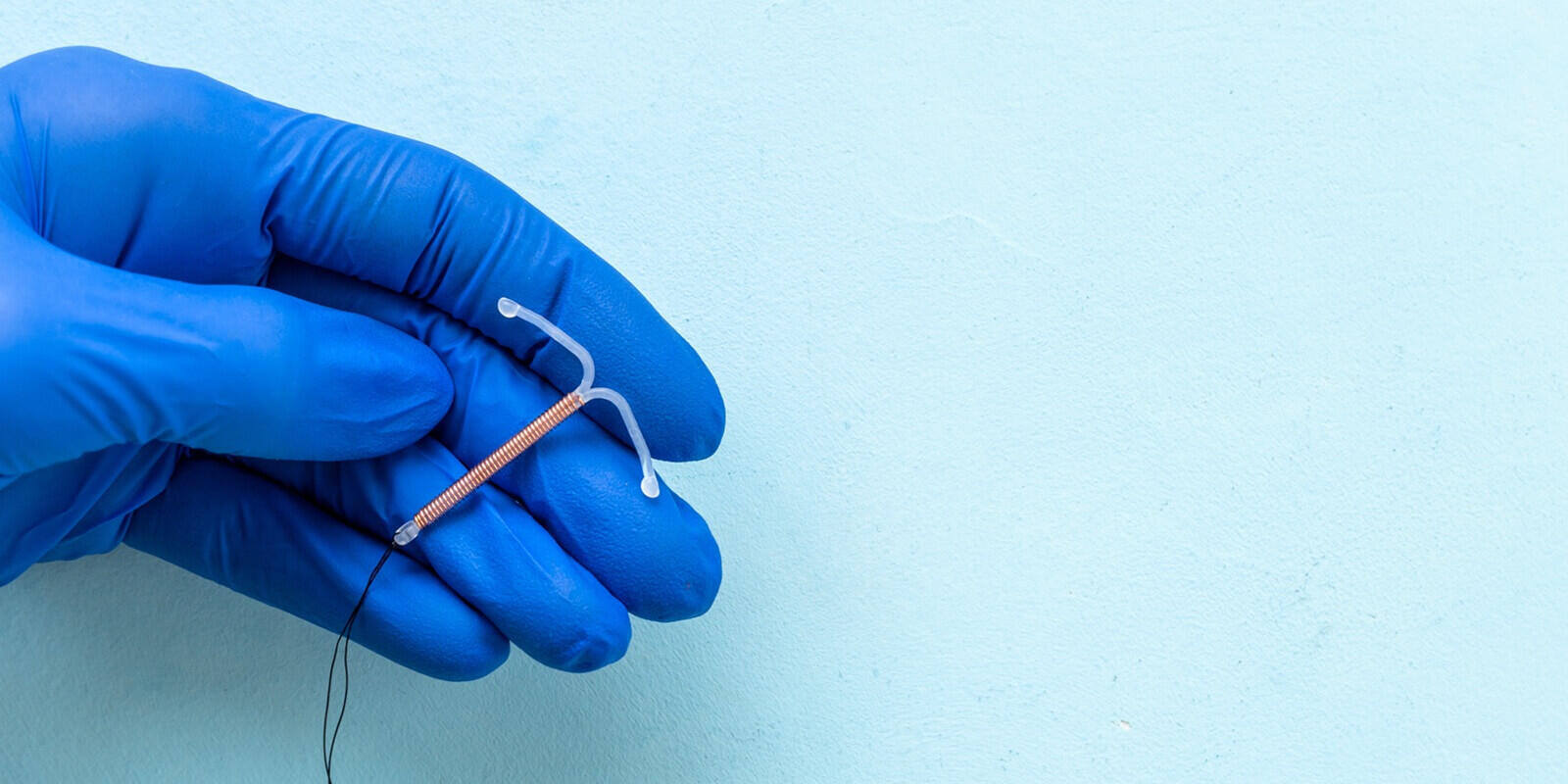 doctor gynecologist holding intrauterine contraceptive device