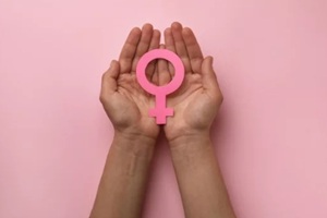 woman holding female gender sign on pink background, top view