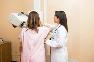 doctor and patient during mammogram study in a hospital