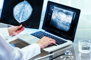 doctor reviewing mammography results on pc
