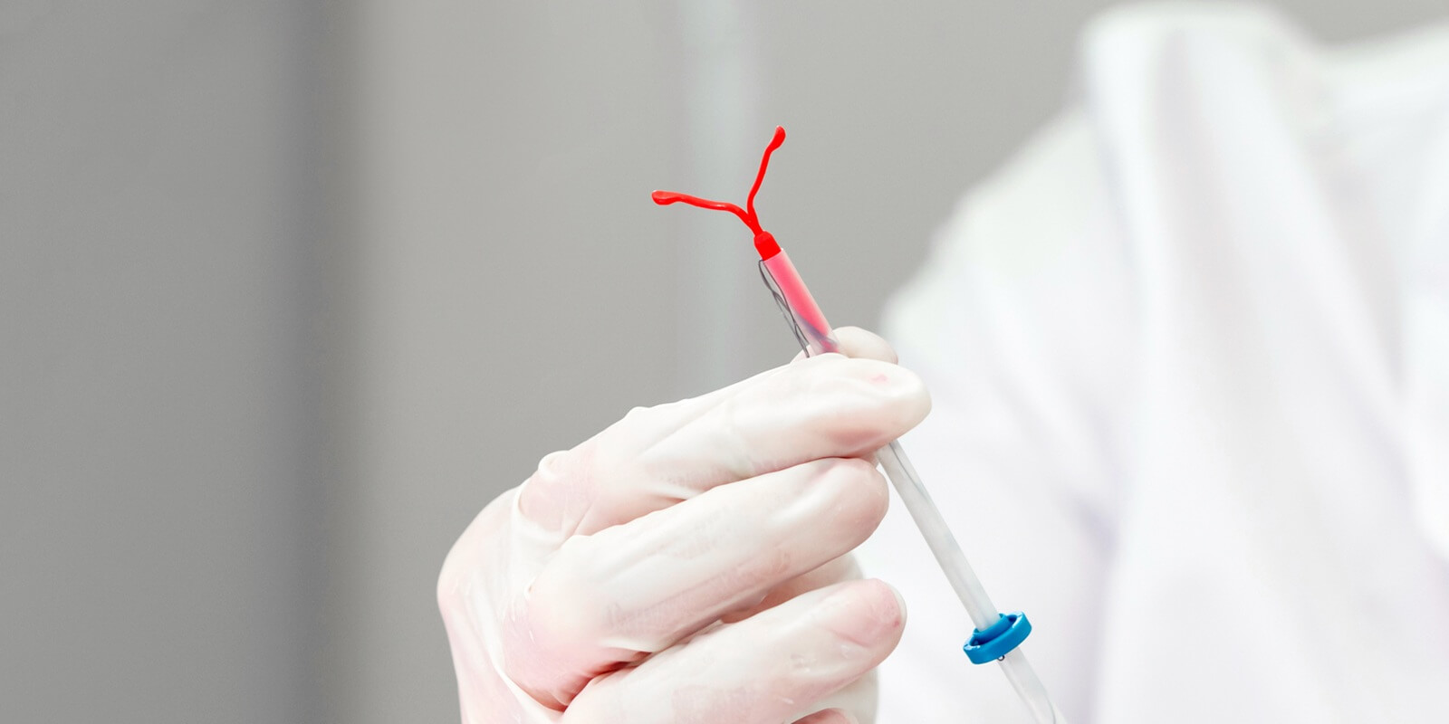 gynecologist holding an IUD birth control device