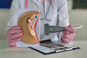 healthcare professional demonstrates ultrasound woman breast and ultrasound results