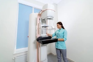 nurse setting up mammogram machine