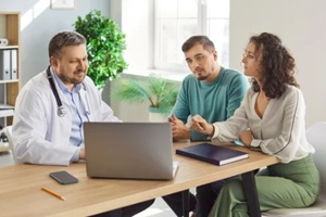 doctor meets patients in clinic centre, consulting family couple, counseling therapy