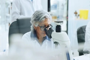microscope, medical research and woman in lab, genetics test and pharmaceutical study