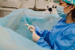 gynecologist demonstrates intrauterine device IUD insertion using uterus model
