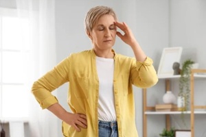 mature woman experiencing menopause at home